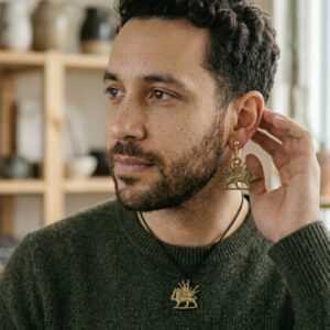 earrings and necklace on Male model-lion and sun
